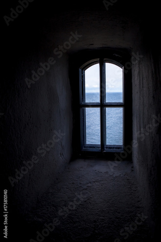 Dark view thought the small window inside the Soderskar lighthouse in Finland Europe