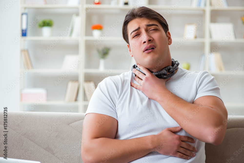 Fototapeta premium Young man suffering from sore throat