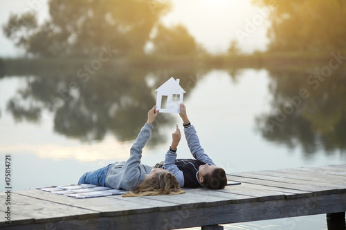 Happy couple of kids dream of a home