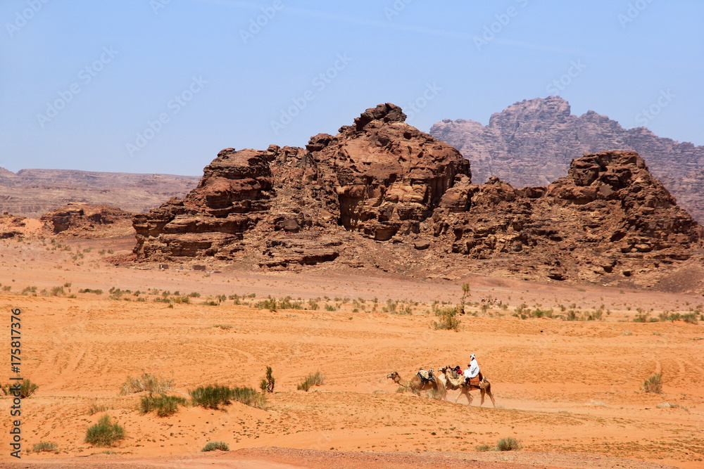 Desert of Wadi Rum with camel riders, Jordan Desert of Wadi Rum with camel riders, Jordan