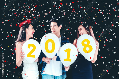 Newyear party ,celebration party group of asian young people holding balloon numbers 2018 happy and funny concept photo