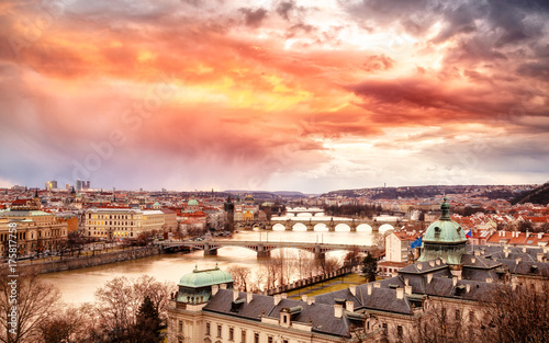 Epic sunset scenery of Prague at Twilight, panorama of Bridges on Vltava, aerial view, beautiful bridges vista. Winter season. Prague is famous and very popular travel destination. Czech Republic.