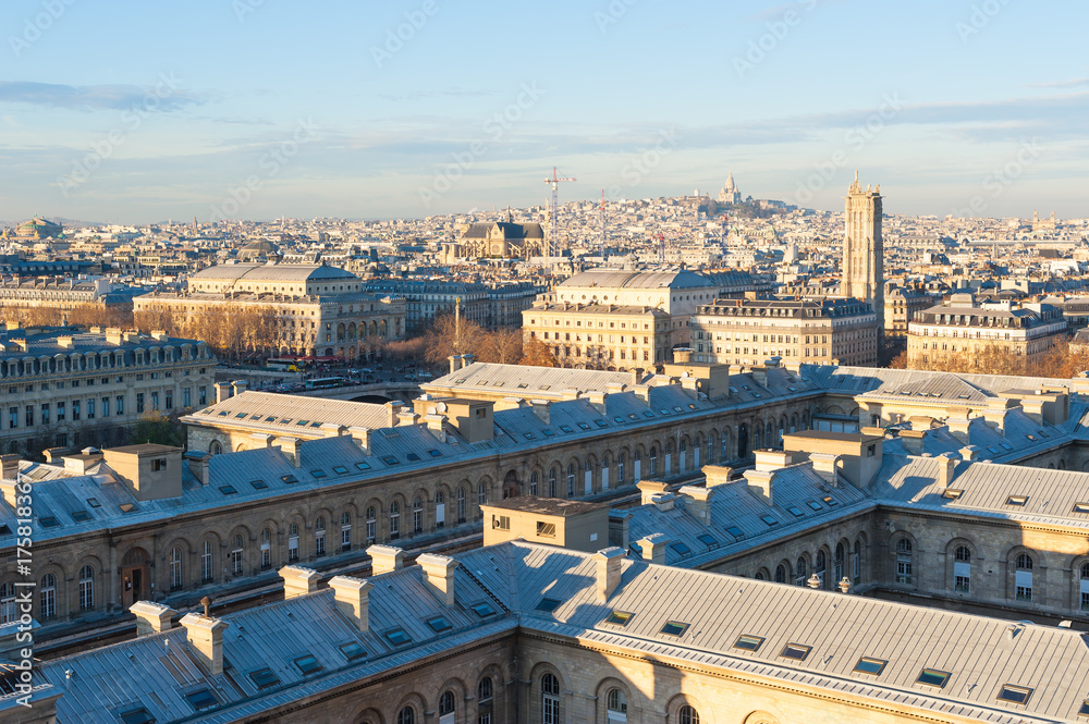 Roofs of Paris with Montmartre in the background on a sunny evening, France