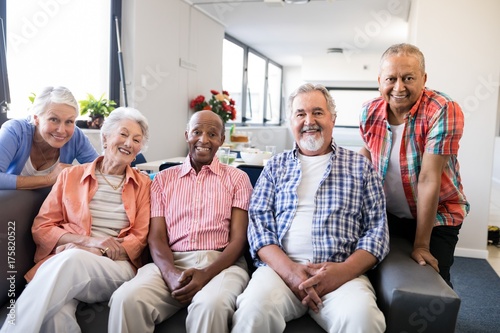 Portrait of multi-ethnic senior people sitting on couch