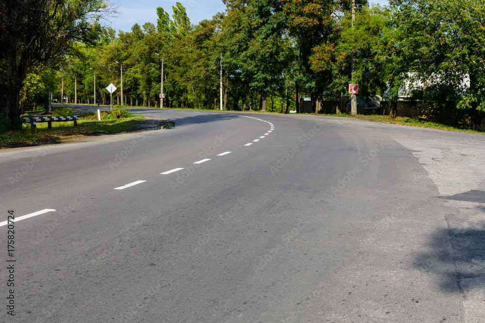 Empty asphalt road with white markings