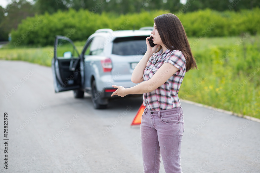 Woman With Flat tire On Car Phoning For Assistance Woman With Flat tire On Car Phoning For Assistance