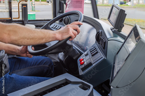 hands of driver in a modern bus by driving, europe