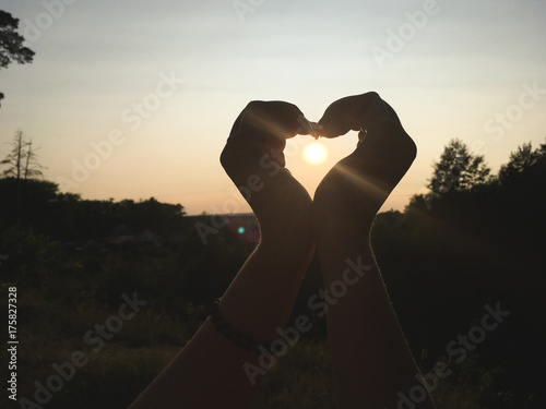 the setting sun in the girl s hand