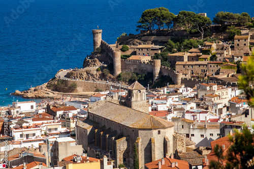 View of the town of Tossa de mar one of the most beautiful towns on the Costa Brava. City walls and medieval castle on the hill. Amazing city in Girona, architecture and monuments of Catalonia. photo