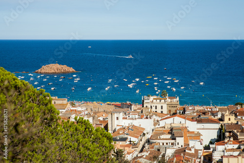 Top view of the town of Tossa de mar, city on the Costa Brava. Buildings and hotels by the beach. Amazing city in Girona, sea and moored boats in Catalonia. City and see.