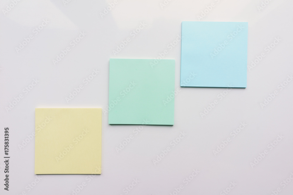 Three square sheet on a white background. Top view. Close-up Three square sheet on a white background. Top view. Close-up