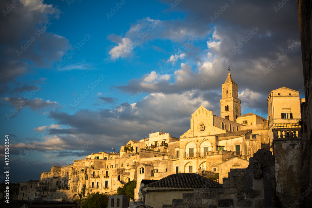 view of the matera town landscape at sunset on cloudy sky background