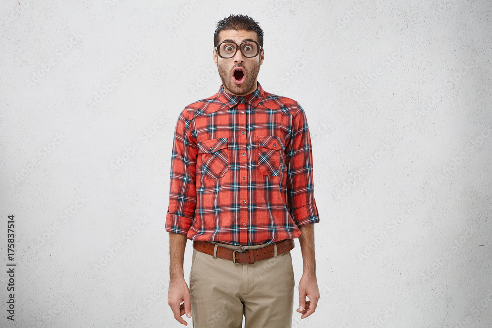 Φωτογραφία Surprised male teacher in square spectacles, look with widely opened mouth, being shocked that pupils escaped from lesson