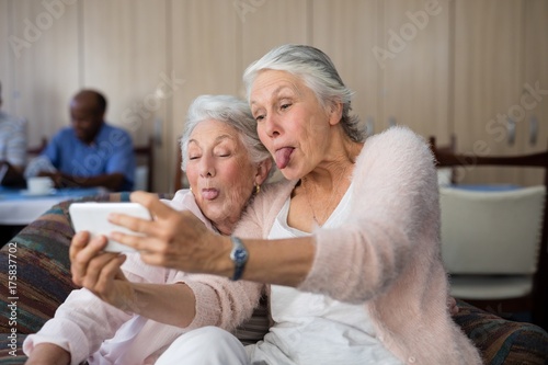 Senior women making face while taking selfie