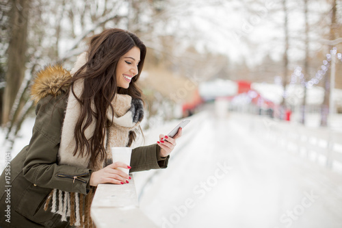 Young woman using phone in ...