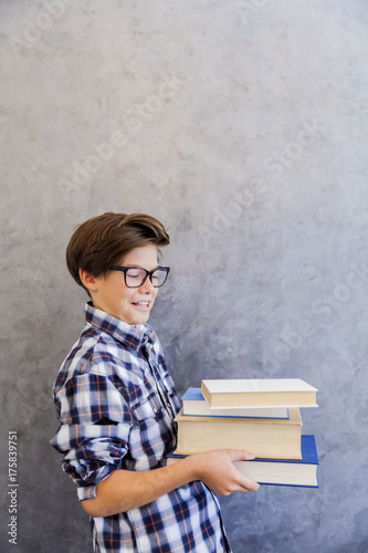Cute teenage school boy hol...