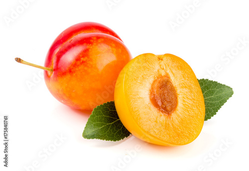 Yellow plum with leaves isolated on white background photo