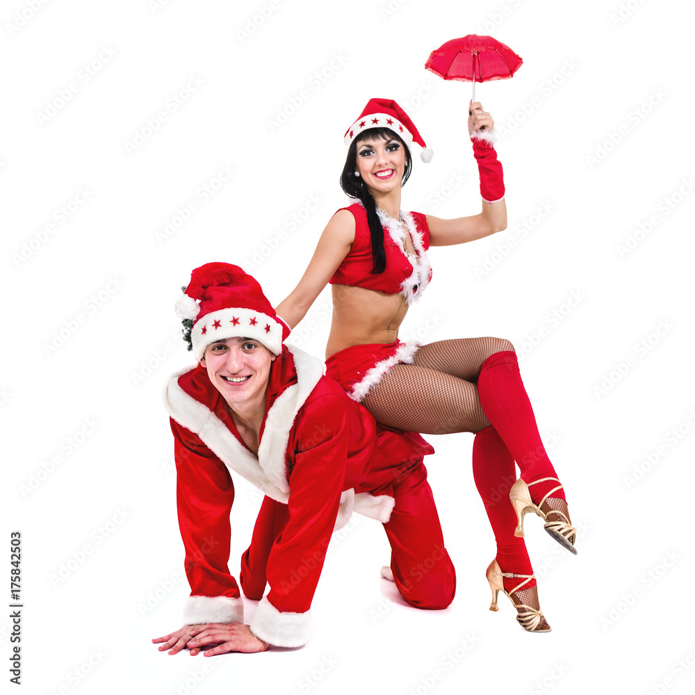 Obraz premium Happy young couple wearing santa claus clothes