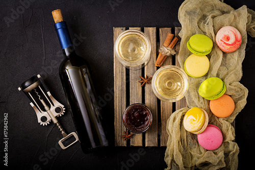 Bottle of dry white wine and a macaroon. Flat lay. Top view.