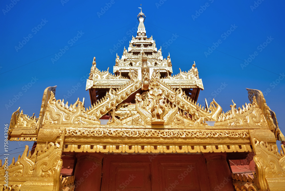 Sculpture golden tympanum of the temple in Myanmar with blue sky