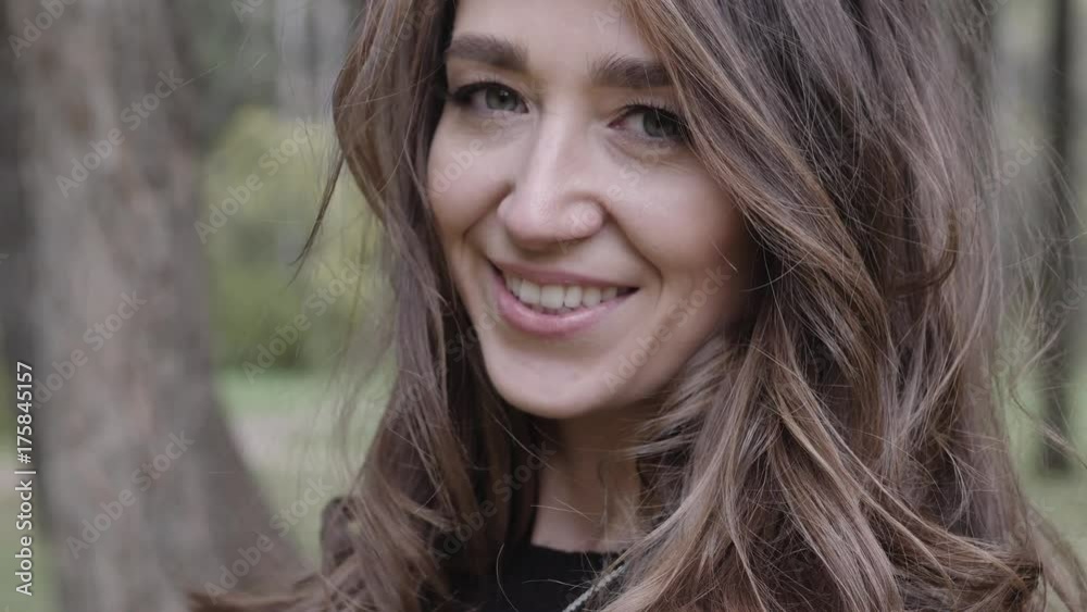 Beautiful girl walks smiling in autumn in the park Beautiful girl walks smiling in autumn in the park