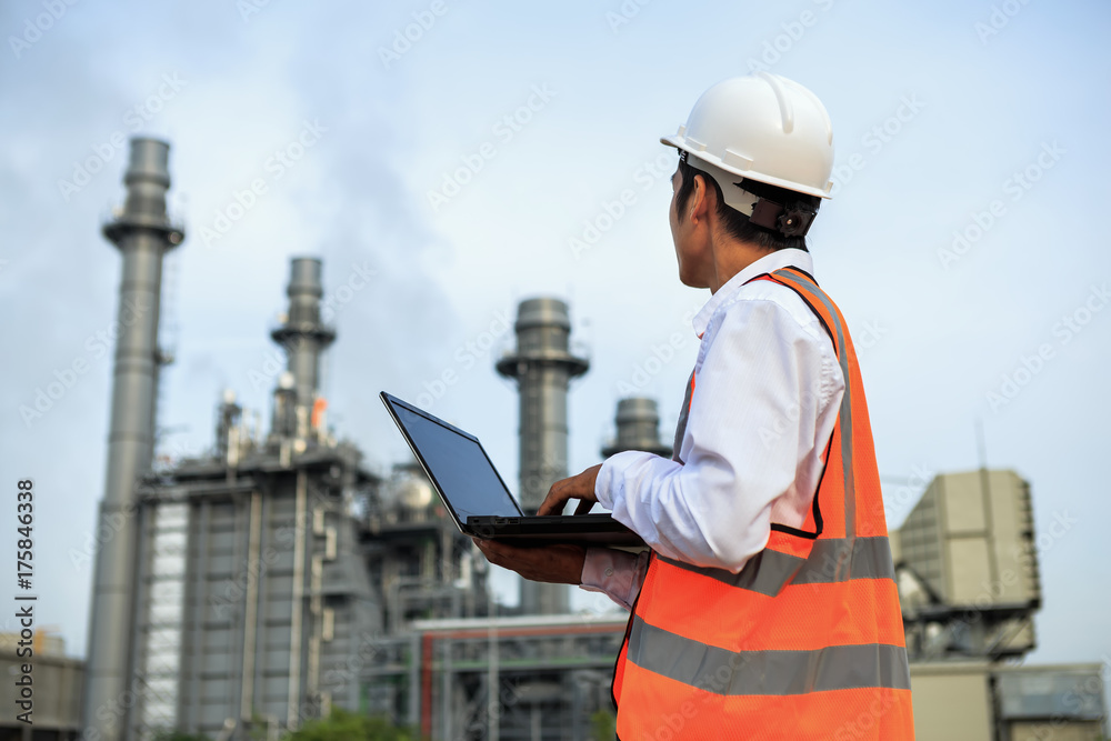 Engineering is working in gas turbine electric power plant he check around plant with notebook Engineering is working in gas turbine electric power plant he check around plant with notebook