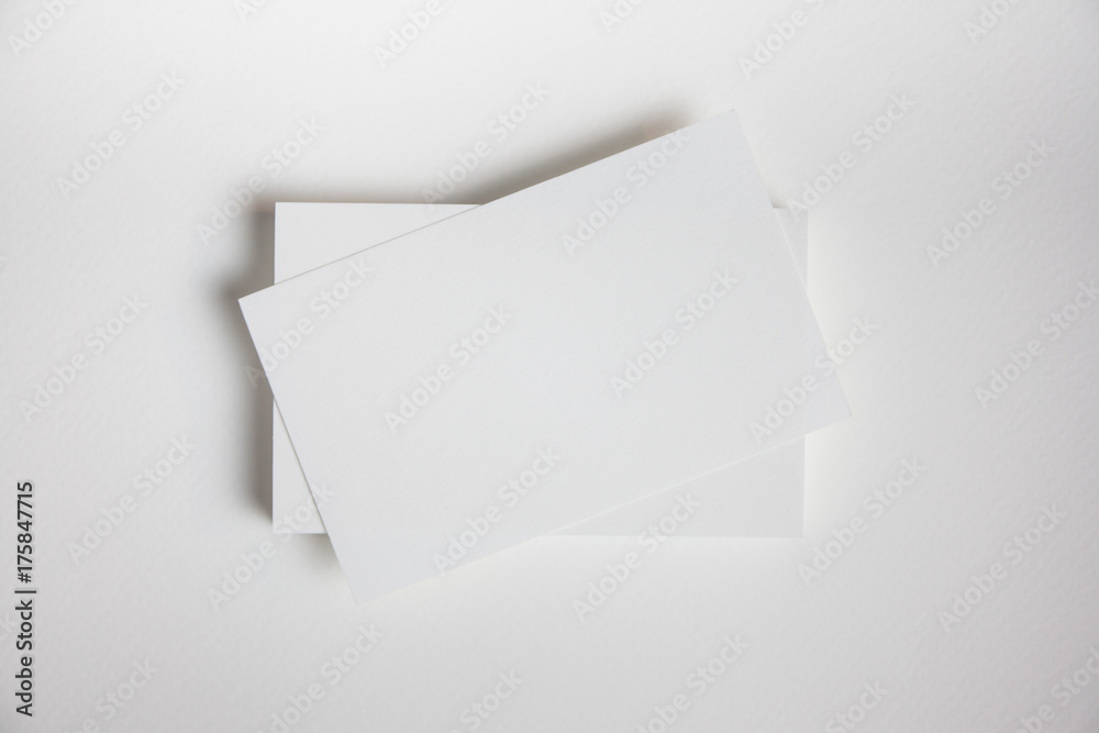 Mockup of business cards fan stack at white textured paper background. Mockup of business cards fan stack at white textured paper background.