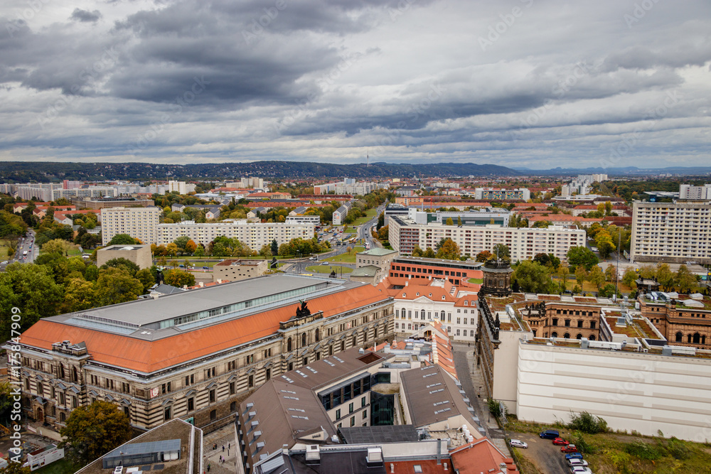 Obraz premium City view of Dresden in east Germany on a stormy autumn October day with the old Plattenbau, prefabricated concrete slabs in the foreground and the beautiful nature of the Sachsiche Schweiz: