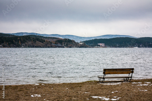 Bench on the lake shore on a winter day