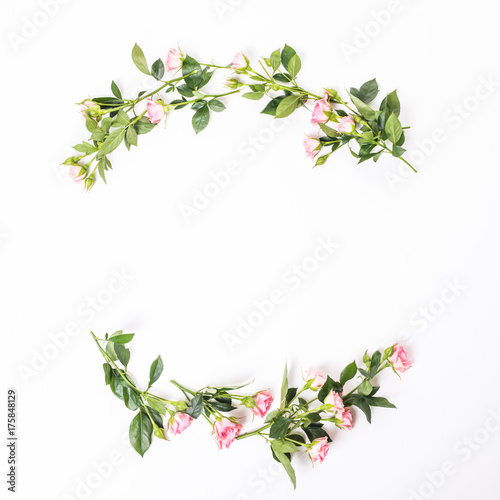 Flowers composition. Frame made of dried rose flowers on white wooden background. Flat lay  top view