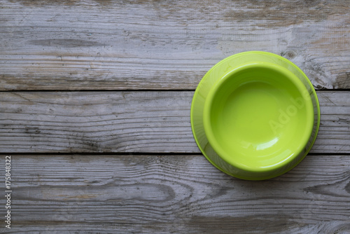 Fototapeta Naklejka Na Ścianę i Meble -  Empty dog food bowl on wood table background