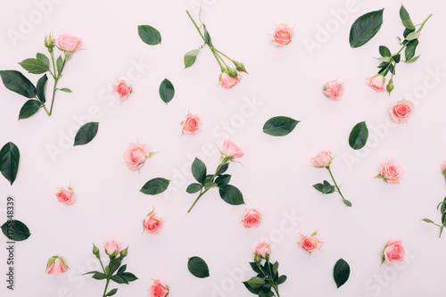 Flowers composition. Frame made of dried rose flowers on white background. Flat lay, top view. photo