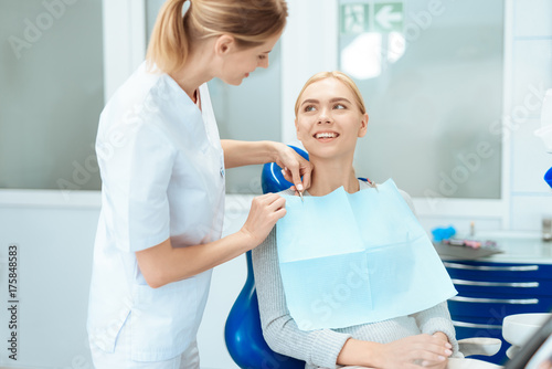 The woman came to the dental clinic. She sits in the dental chair and smiling