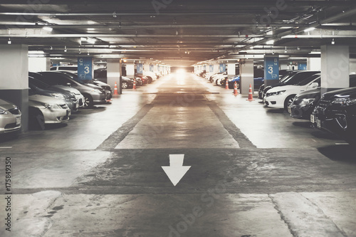 Many cars in parking garage interior, industrial building. Vintage filter effect. © Natee Meepian