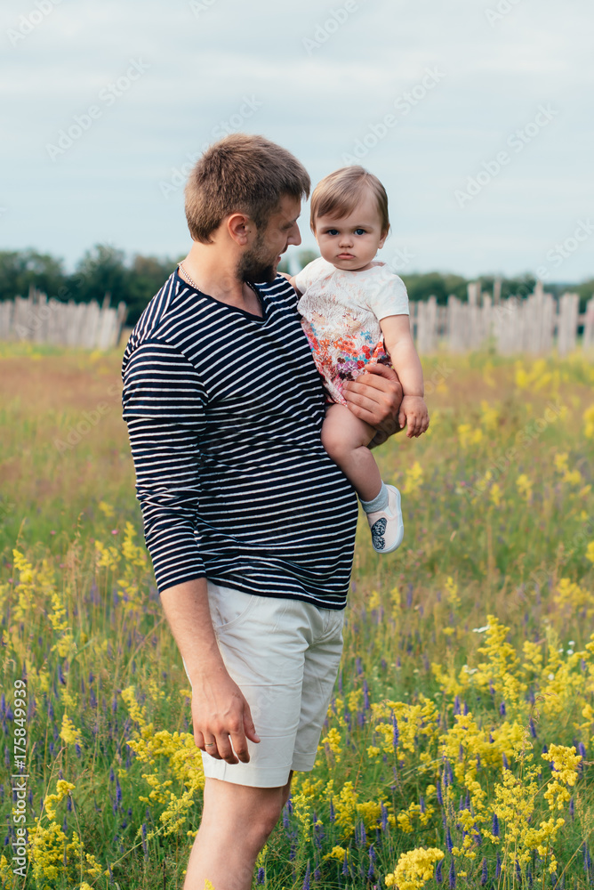 happy father with little daughter in the park, summer outdoors happy father with little daughter in the park, summer outdoors