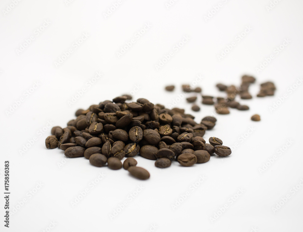 Isolated dark roasted coffee beans on white background