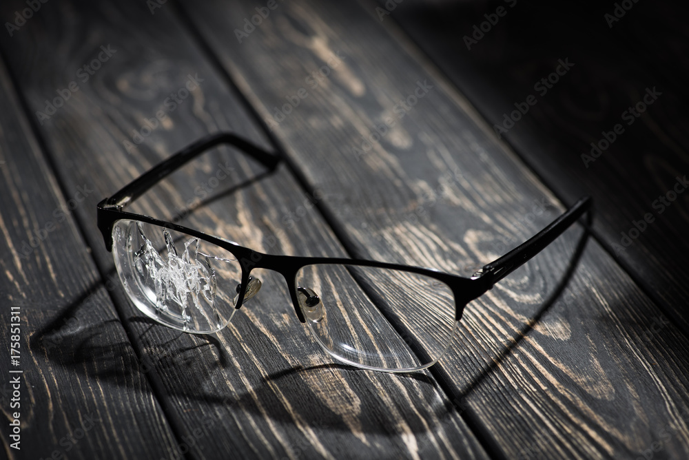 broken glasses on a wooden table