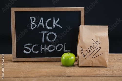 Lunch paper bag, green apple and slate with text back to school