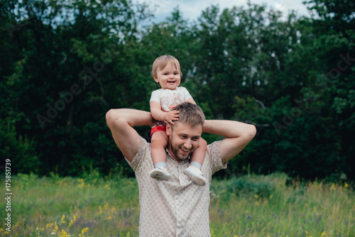 happy father with little daughter in the park, summer outdoors photo