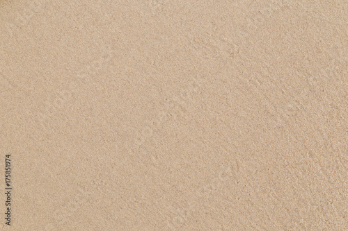 Close-up of smooth sand at a beach texture background.