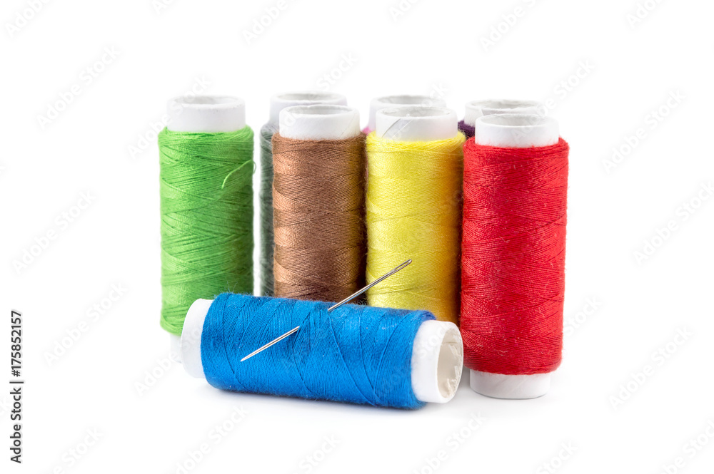 Colored threads with sewing needle on a white. Colored threads with sewing needle on a white.