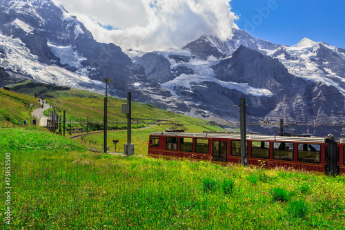 Red tourist train from Kleine Scheidegg to Jungfraujoch in summer