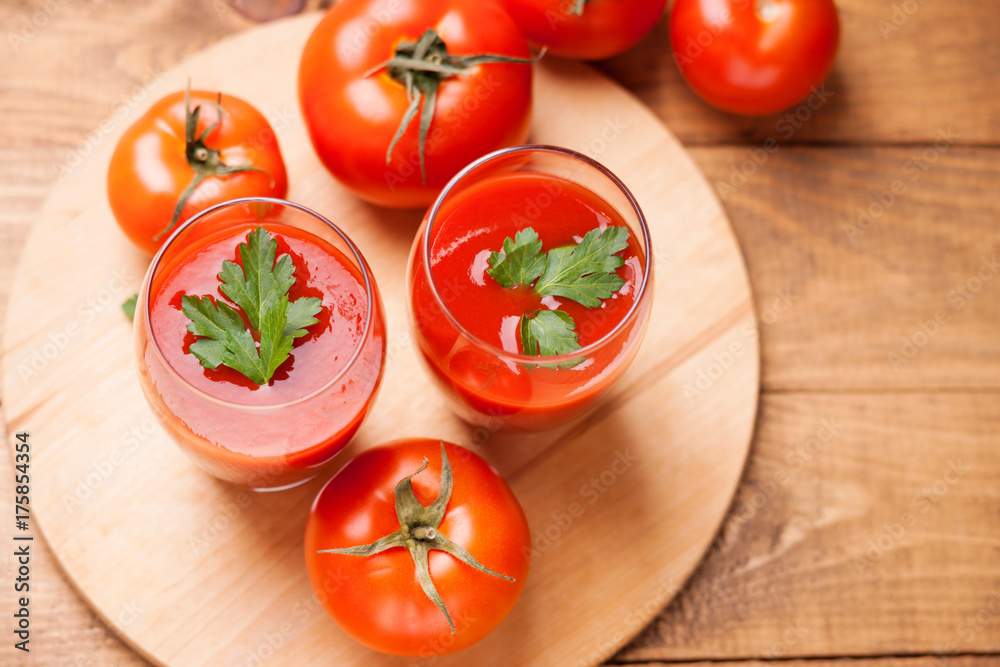 Glasses of fresh tomato juice and tomatoes Glasses of fresh tomato juice and tomatoes