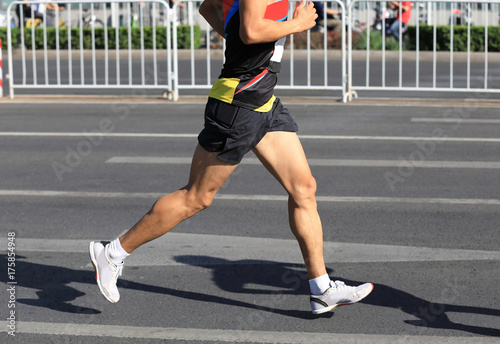 Marathon runner running on city road