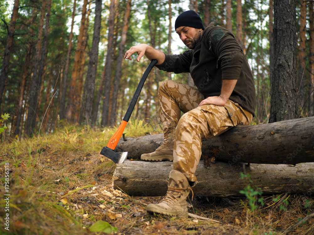 Lumberjack worker sitting in the forest .Resting after hard work. Stock  Photo | Adobe Stock
