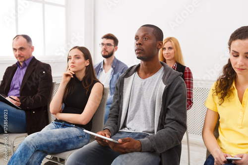 Group of people sitting at seminar, copy space