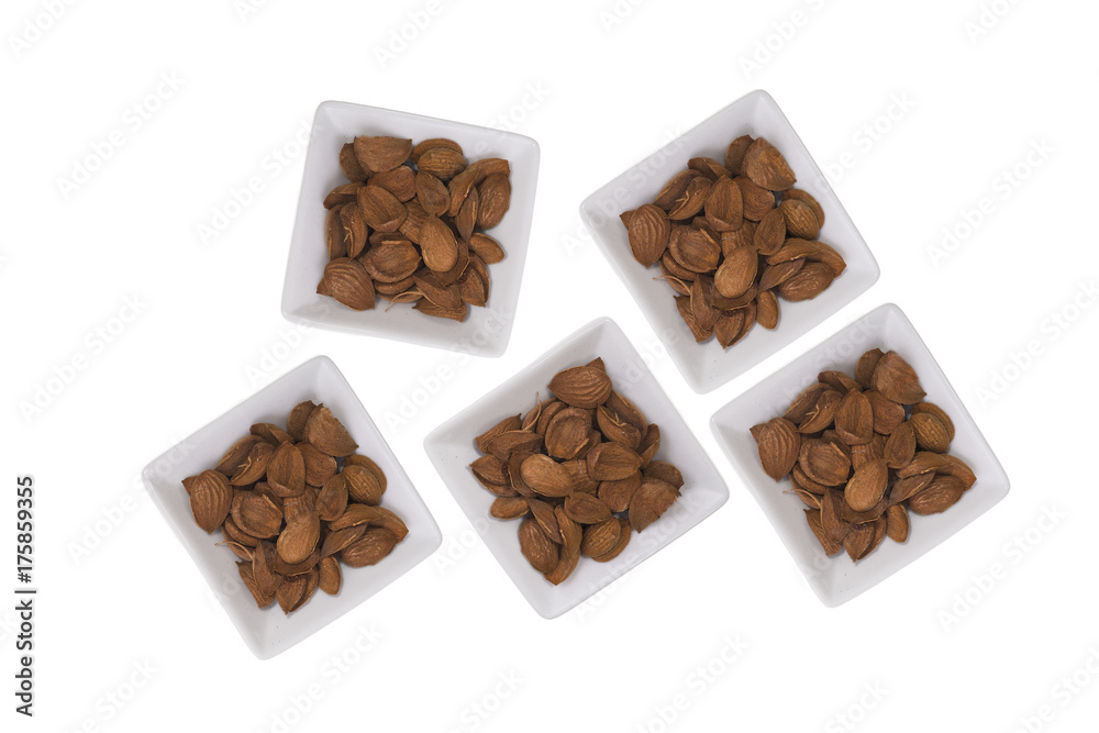 Almonds over white background. / Composition with almonds white pots over white background. Space for text Almonds over white background. / Composition with almonds white pots over white background. Space for text