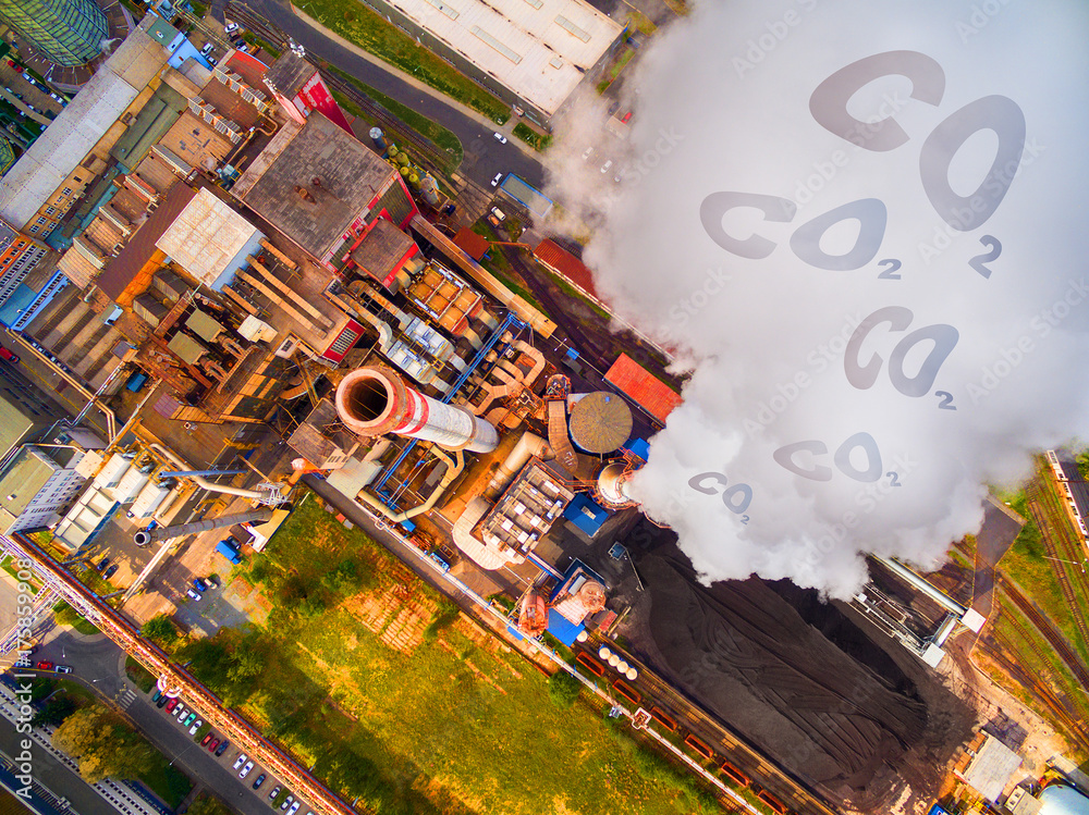 Aerial view to smoking chimmney from lignite power plant. Digital artwork on air pollution and climate change theme. Heavy industry from above.