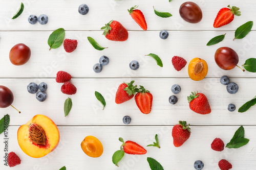 Assorted berries on white wooden table top view