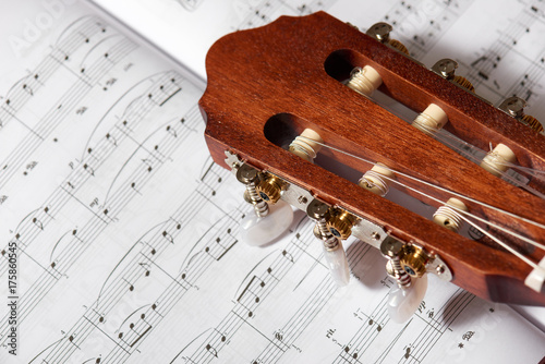 closeup of acoustic guitar on music notes